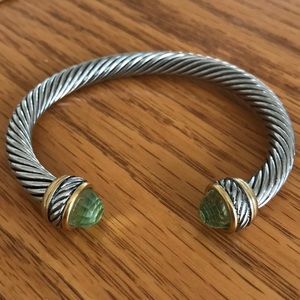 Silver bracelet with green gem opening